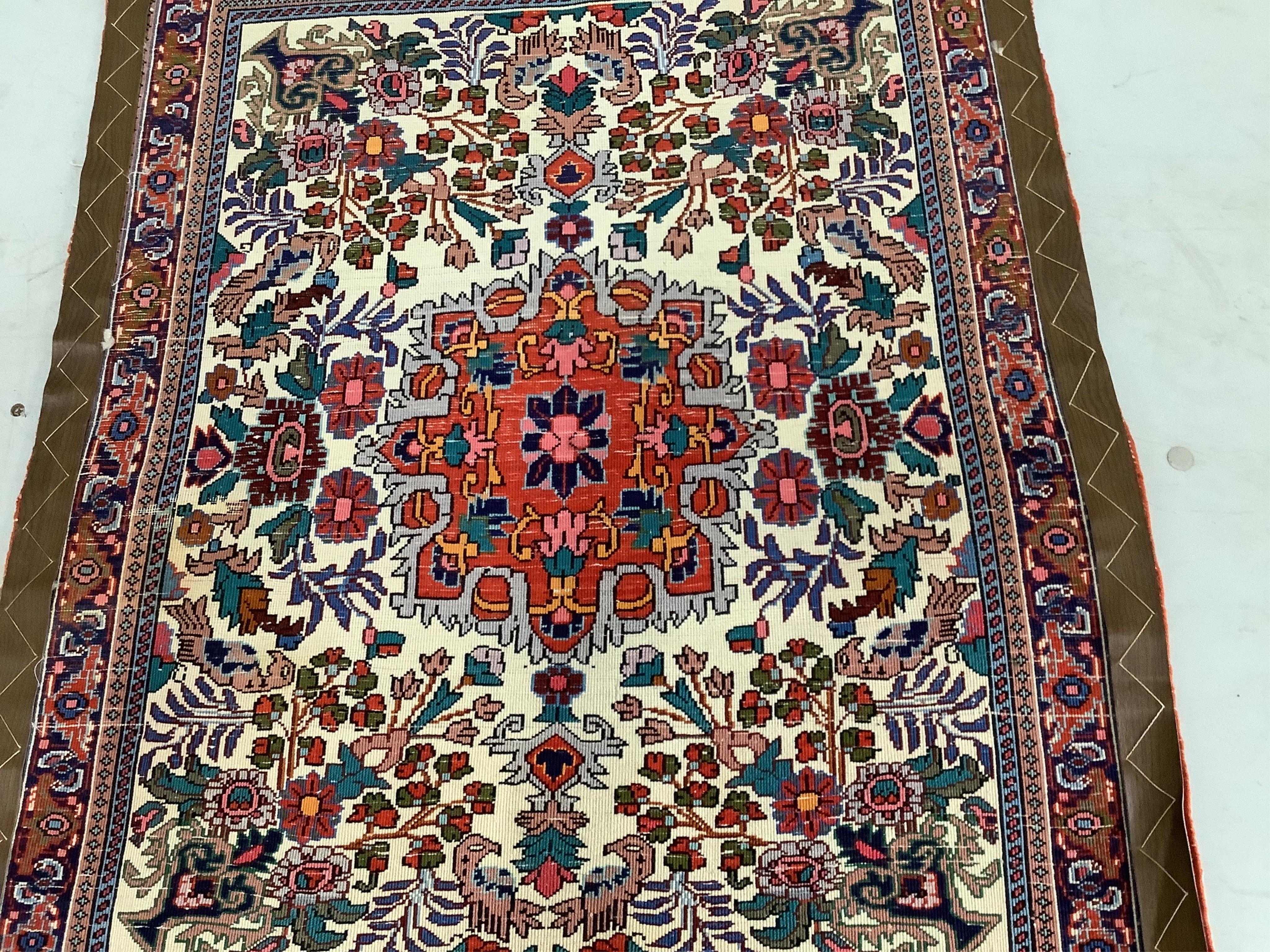 A North West Persian ivory ground mat, 86 x 70cm. Condition - fair